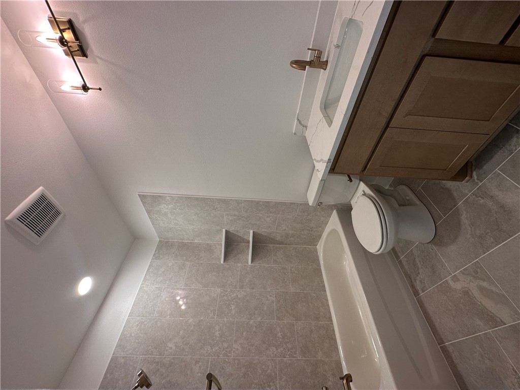 4302 Conestogo Court Bryan, TX 77802 - Photo 23 of 34 a bathroom with a sink a toilet and shower