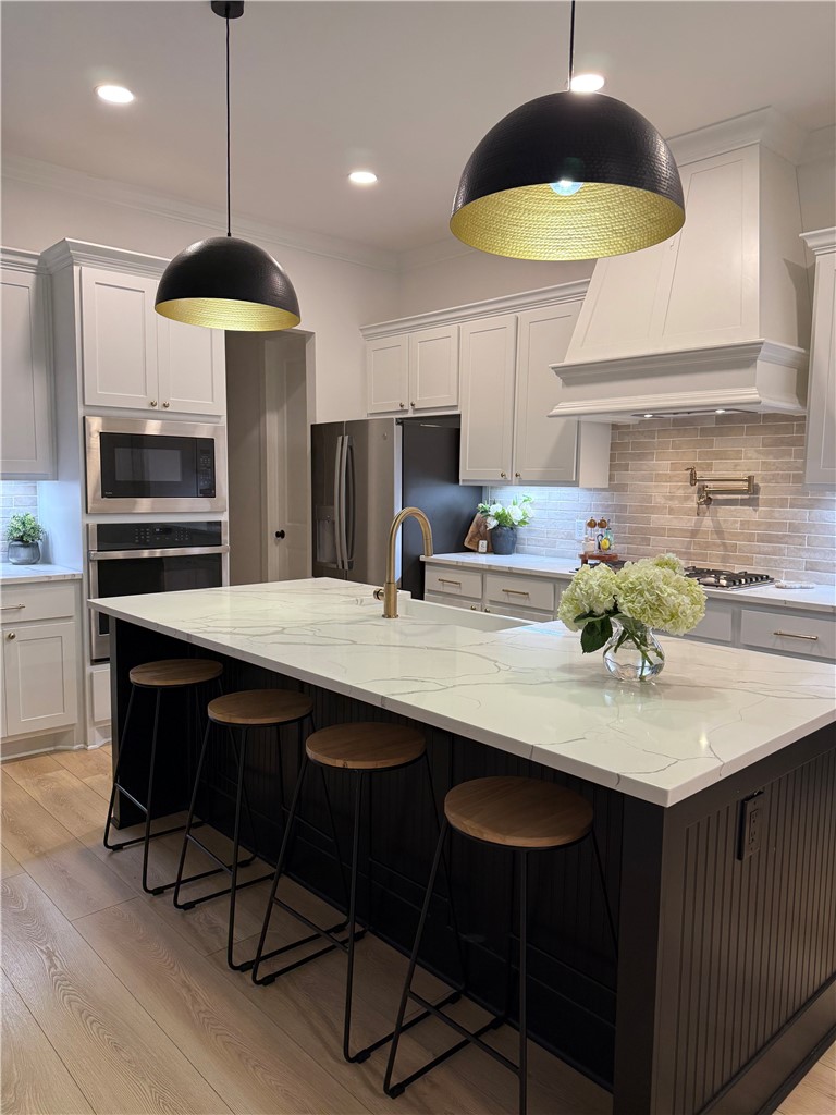 4302 Conestogo Court Bryan, TX 77802 - Photo 30 of 34 a kitchen with stainless steel appliances a dining table chairs and a refrigerator