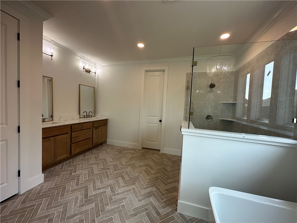 4302 Conestogo Court Bryan, TX 77802 - Photo 6 of 34 a bathroom with a mirror a double vanity sink and mirror