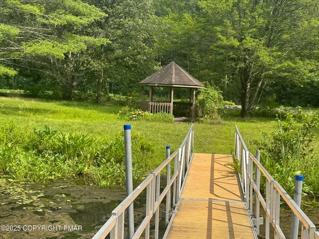 a view of a wooden deck with a yard