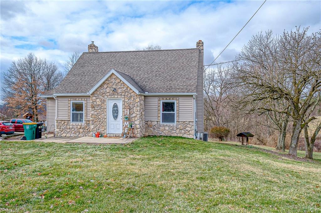 1318 Oakridge Road McDonald, PA 15057 - Photo 2 of 25 a front view of house with yard and trees in the background