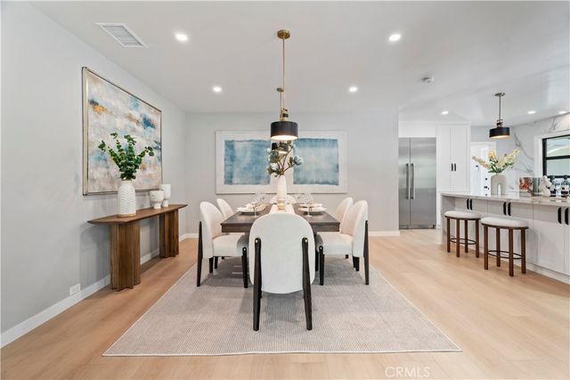 a kitchen that has a table and chairs in it