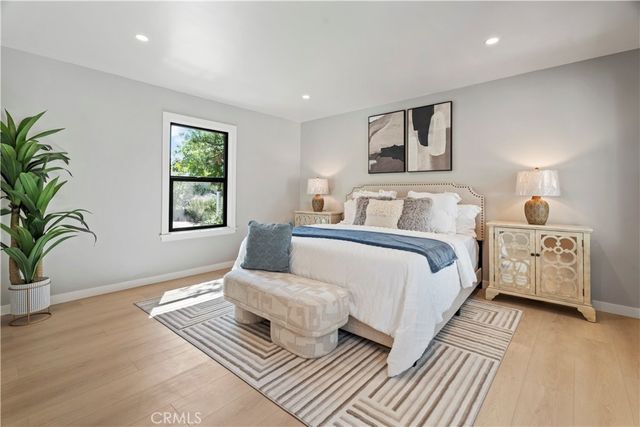 a bedroom with a bed and a large window