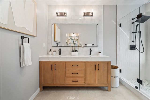 a bedroom with a large bed and a potted plant
