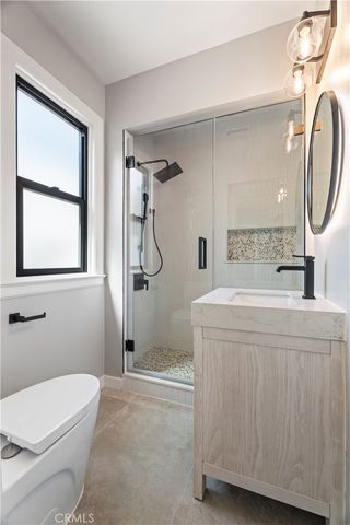 a bathroom with a double vanity sink toilet mirror and bathtub