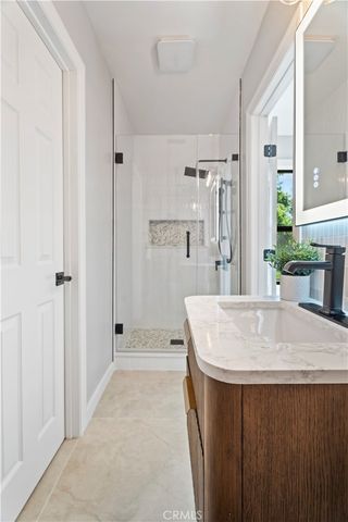 a bathroom with a sink a mirror and a shower