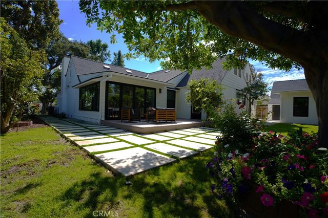 a view of a house with pool and garden