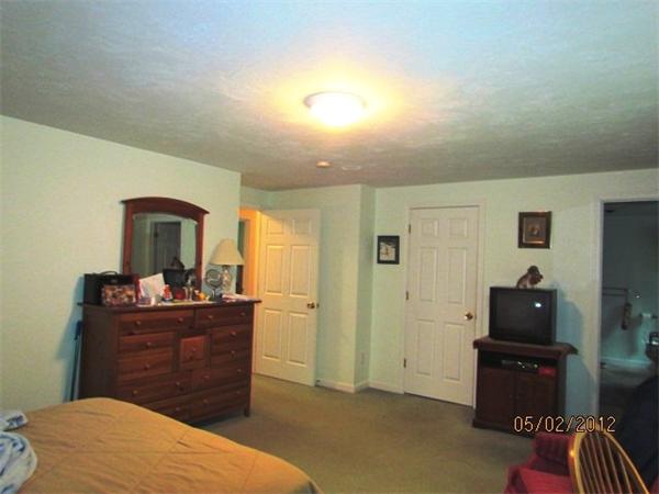 402 New Boston Road Sturbridge, MA 01566 - Photo 16 of 16 a bedroom with a bed and a dresser