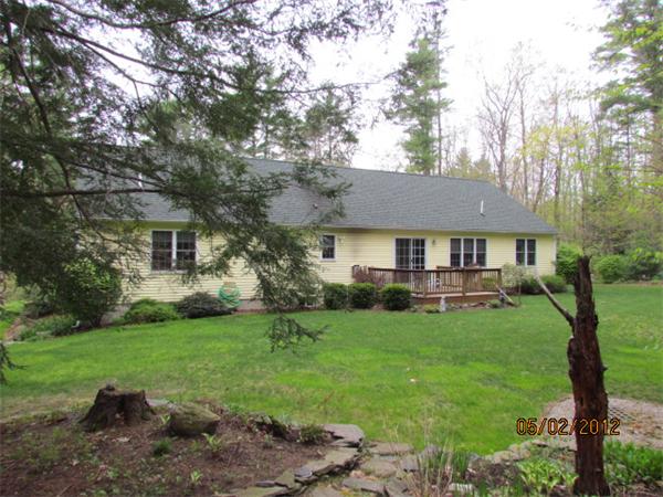 402 New Boston Road Sturbridge, MA 01566 - Photo 2 of 16 a front view of a house with a yard