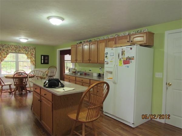 402 New Boston Road Sturbridge, MA 01566 - Photo 3 of 16 a kitchen with stainless steel appliances granite countertop a refrigerator a sink a stove and a dining table with wooden floor