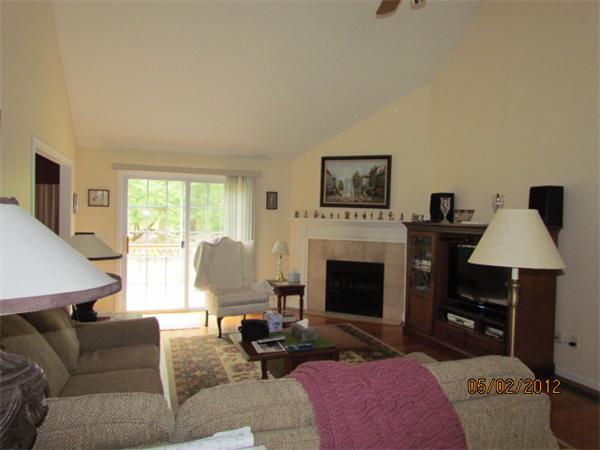 402 New Boston Road Sturbridge, MA 01566 - Photo 8 of 16 a living room with furniture a flat screen tv and a fireplace
