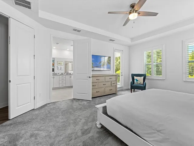 a bedroom with two beds and a painting on the wall