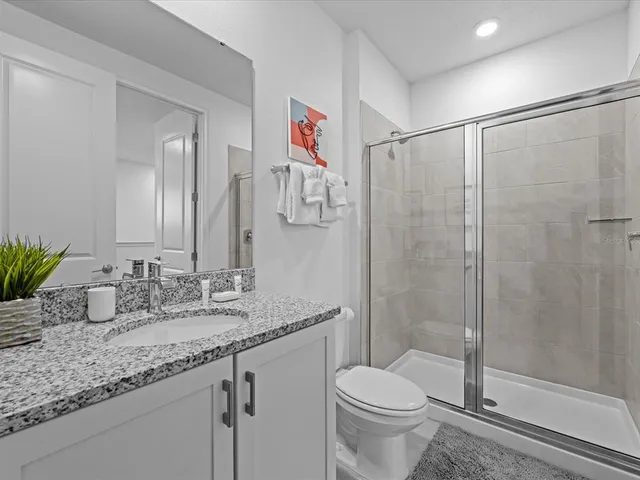 a view of a dining room with furniture wooden floor and a floor to ceiling window