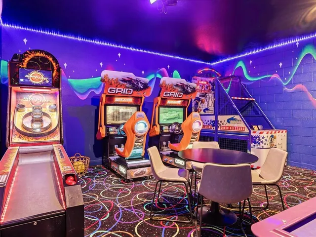 a spacious bathroom with a granite countertop sink a mirror a bathtub and next to a window