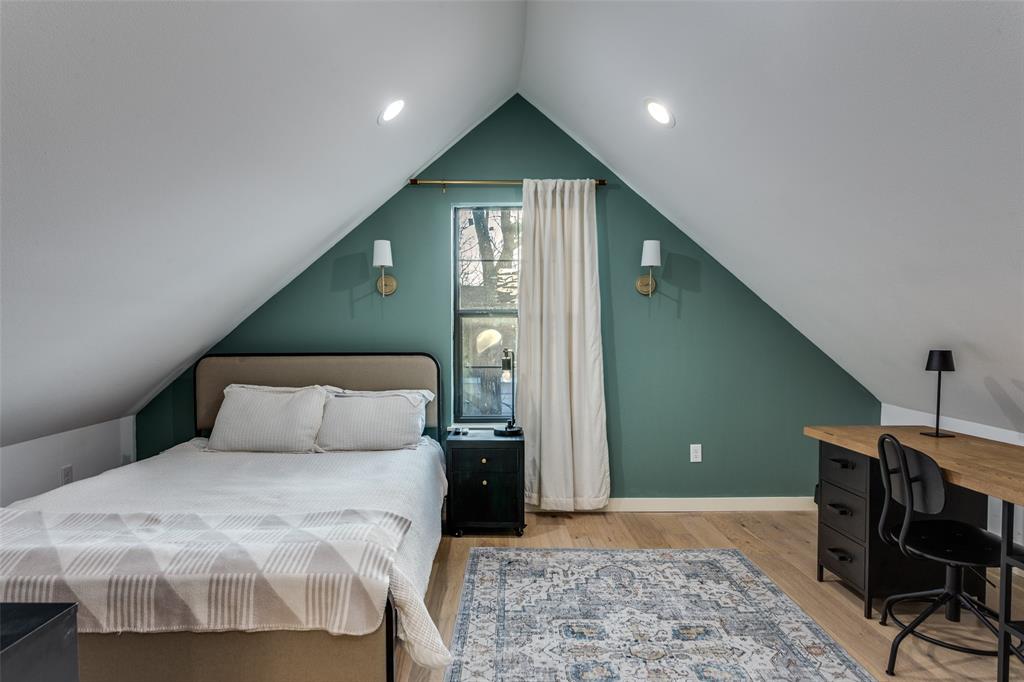 3120 Colcord Avenue Waco, TX 76707 - Photo 21 of 23 a bedroom with a large bed and wooden floor