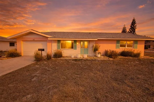 a view of house with backyard