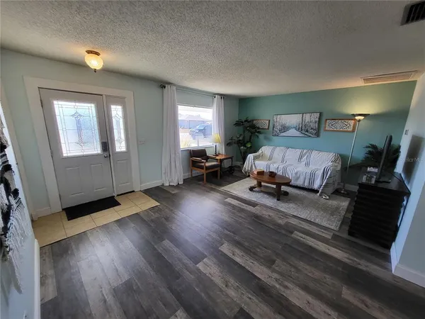 a living room with furniture rug and window