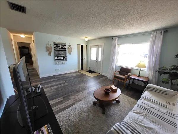 a view of a closet area with racks on the wall