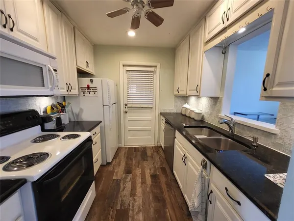 a kitchen with a sink stove and refrigerator