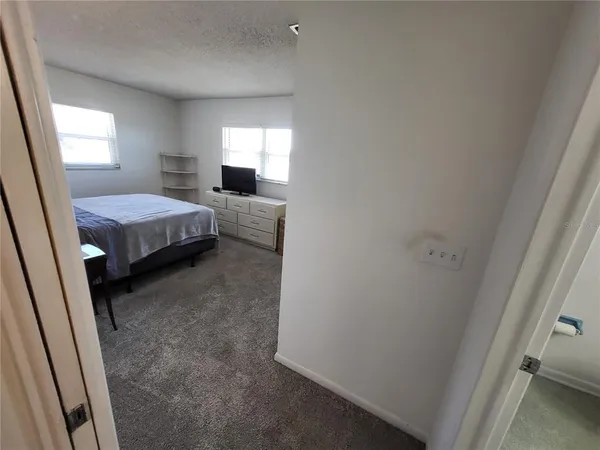 a bedroom with bed and a window