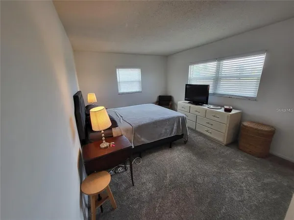 a bedroom with a bed and a chair