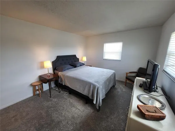 a bedroom with a bed and a lamp