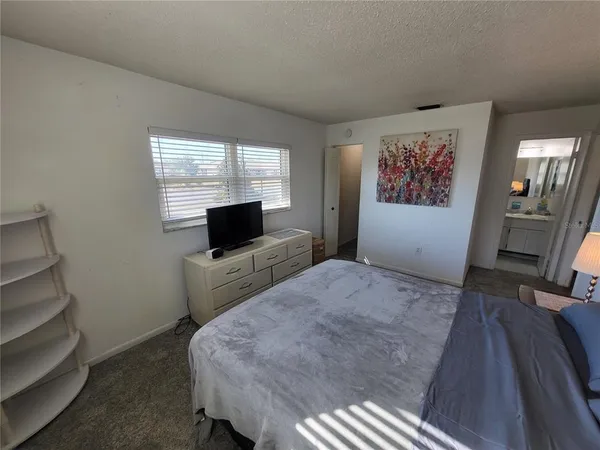 a bedroom with bed and window
