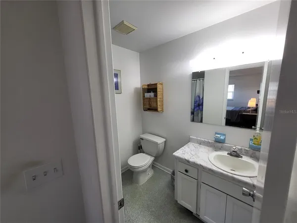 a bathroom with a toilet and a shower curtain