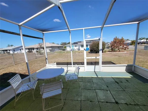 a backyard of a house with outdoor seating