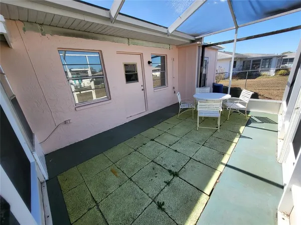 a view of a house with backyard and sitting area
