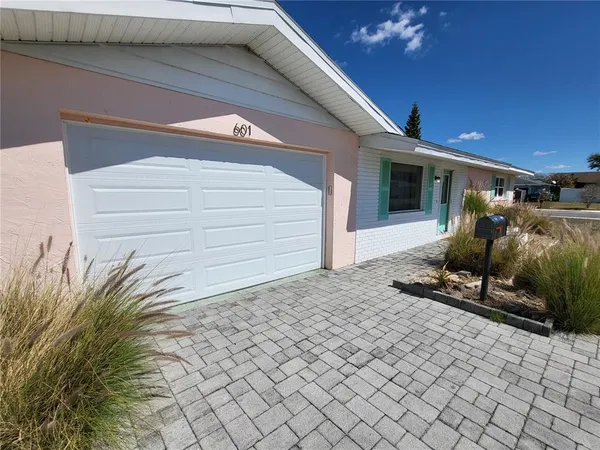 a view of a door of a house with a yard