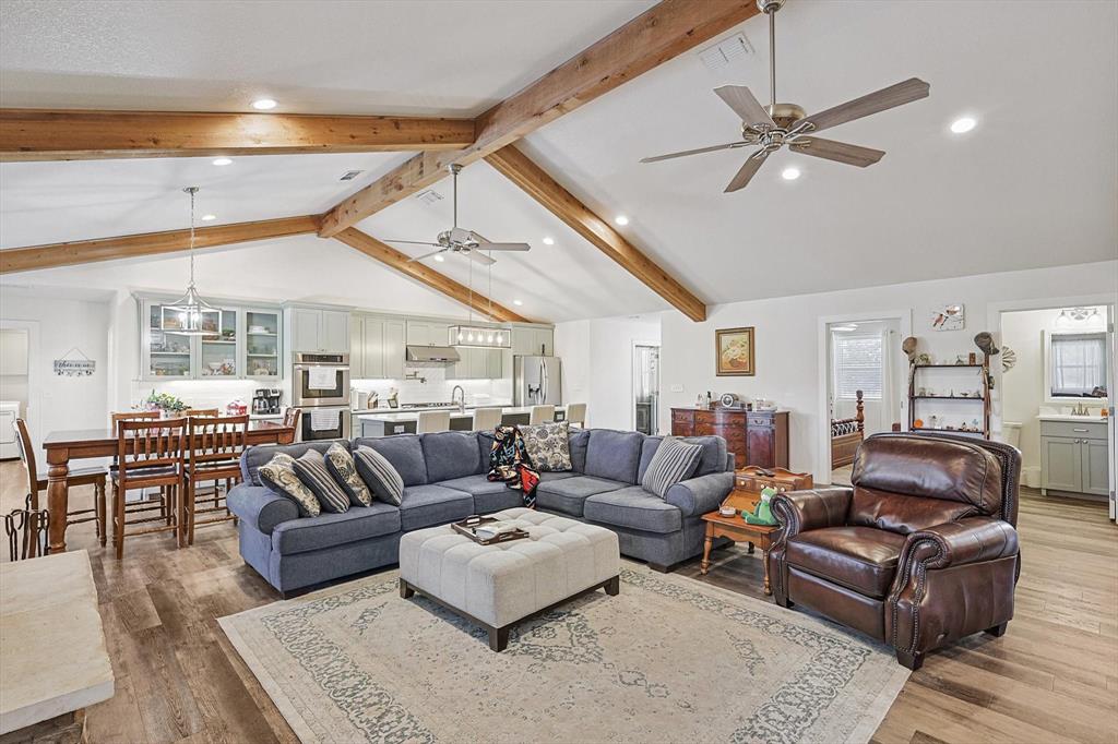 1161 Lynn Creek Road Jacksboro, TX 76458 - Photo 12 of 40 Living room featuring ceiling fan, lofted ceiling with beams, and light hardwood / wood-style floors