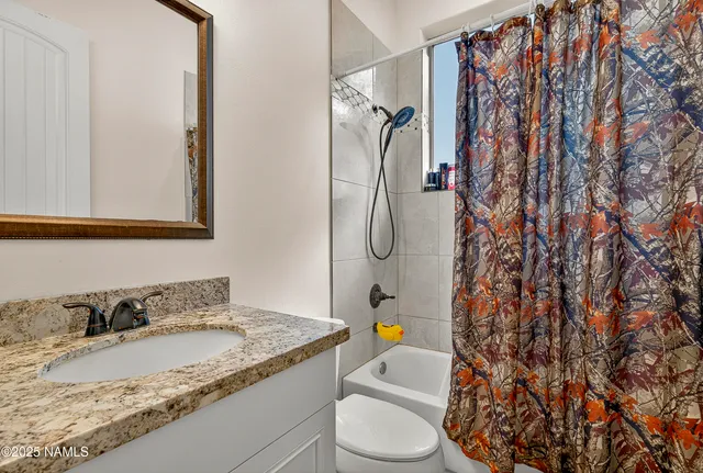 a backyard of a house with barbeque oven table and chairs