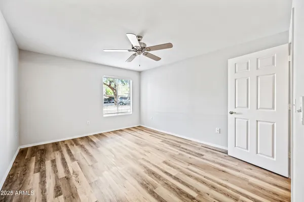 a view of empty room with wooden floor