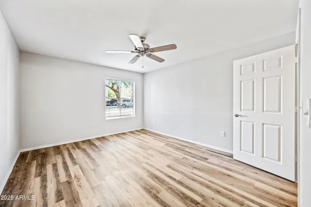 a view of empty room with wooden floor