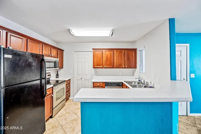 a kitchen with stainless steel appliances a sink and a refrigerator