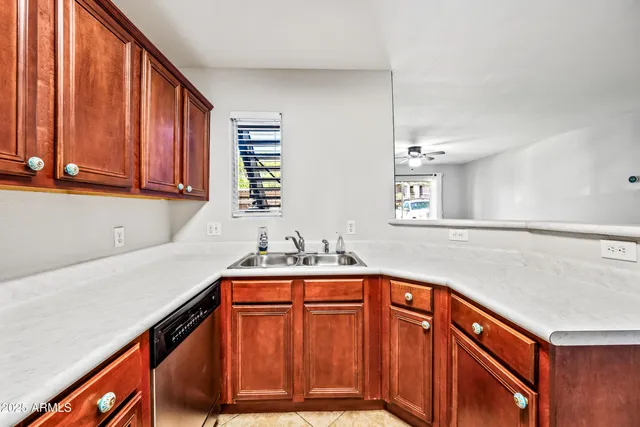 a kitchen with a sink cabinets and window