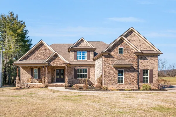 a front view of a house with a yard
