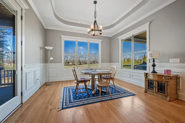 a view of a dining room with furniture window and wooden floor