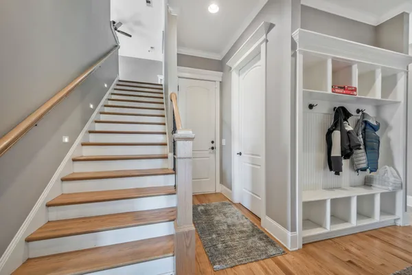 a view of a hallway with closet and stairs