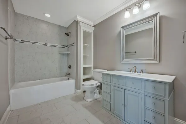 a bathroom with a bathtub toilet sink vanity and mirror