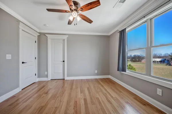 wooden floor in an empty room with a window