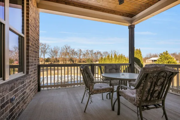 a view of a balcony with chairs