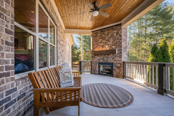 a view of a porch with furniture and a fireplace