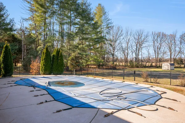 a view of a swimming pool with an outdoor space and seating area
