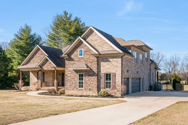 a front view of a house with a garden