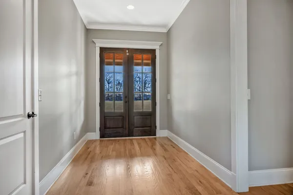 a view of empty room with wooden floor