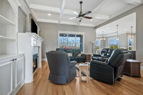 a living room with furniture and a chandelier