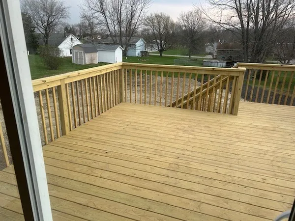 a view of balcony with wooden floor