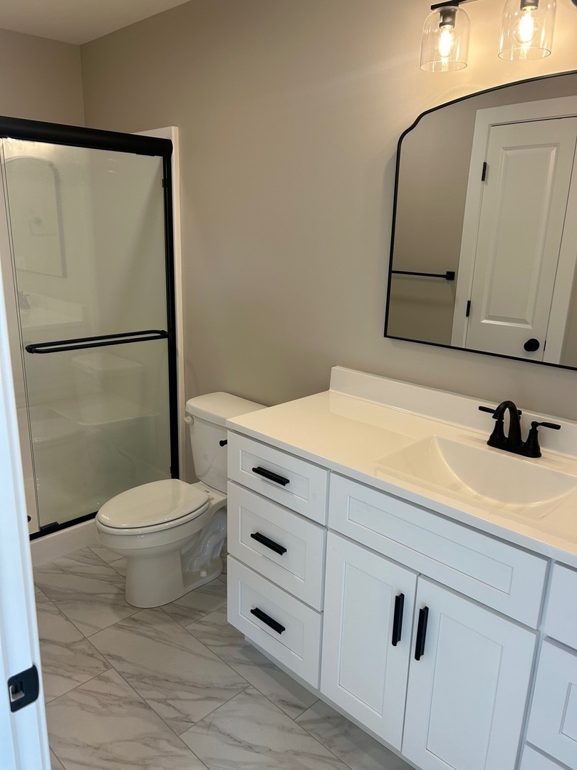 25179 North 2175 East Road Lexington, IL 61753 - Photo 9 of 23 a bathroom with a sink a toilet and a mirror